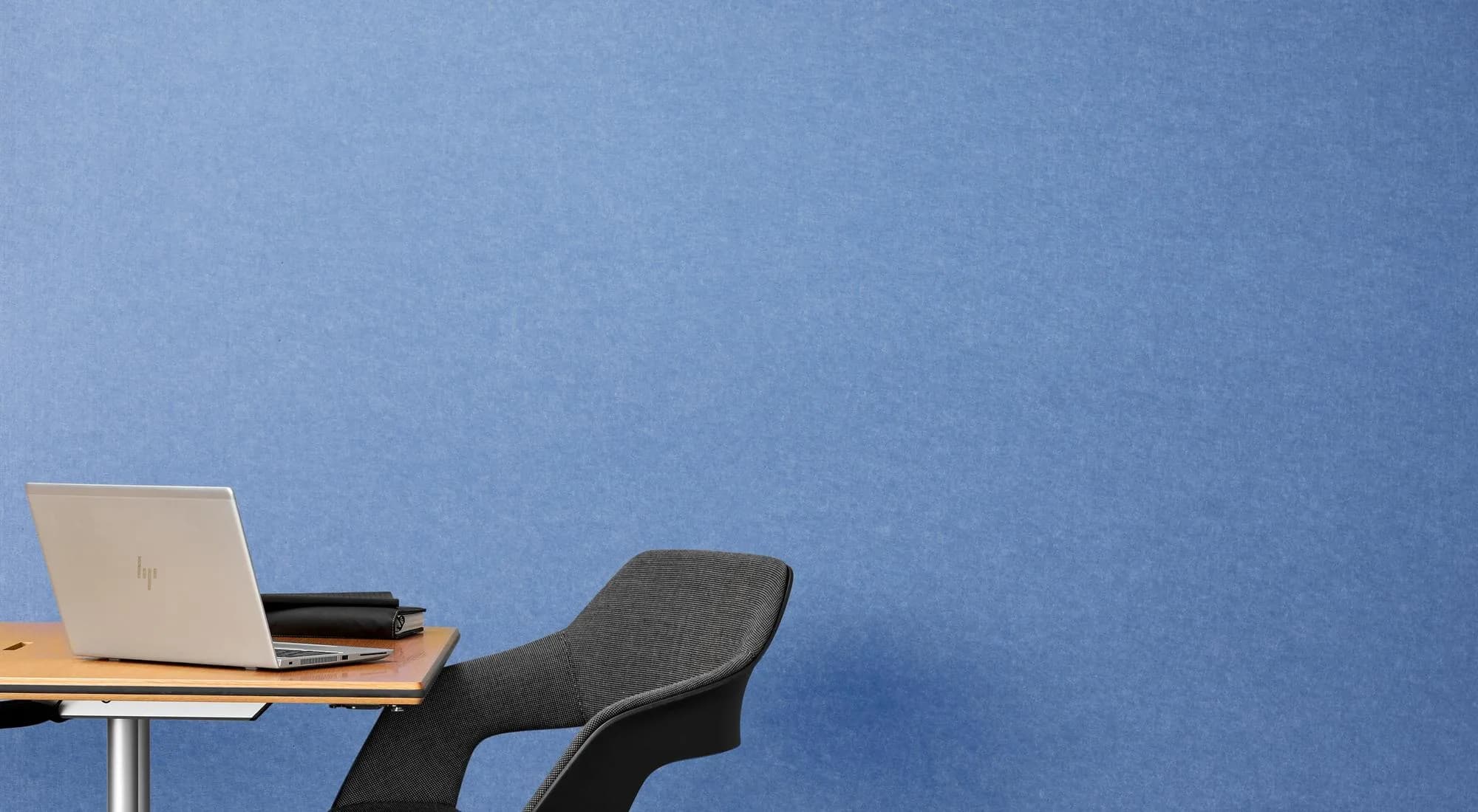 EchoPanel 12mm acoustic panels in bright blue as a feature wall behind a desk and laptop
